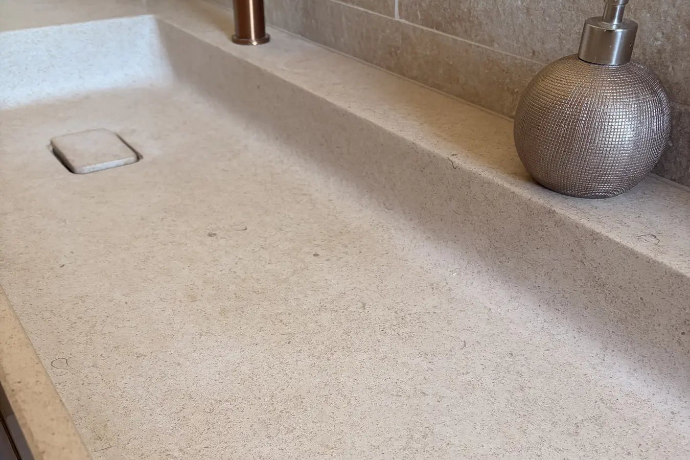Gros plan sur la texture et le grain naturel d'une vasque en pierre calcaire